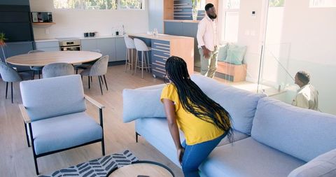 Welcoming Guest with Friendly Handshake in Modern Living Room