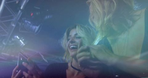 Laughing Friends Enjoying Nightclub under Neon Lights