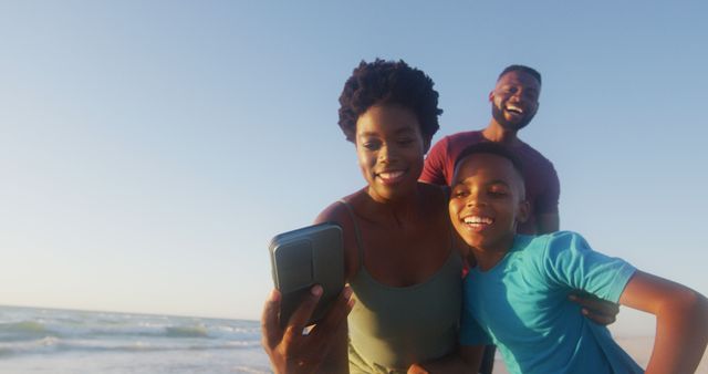 Family Enjoying Selfie on Beach at Sunset - Download Free Stock Images Pikwizard.com