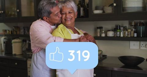 Senior Couple Embracing in Kitchen with Social Media Interaction