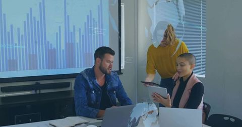 Professionals Collaborating on Data Analysis in Modern Corporate Setting