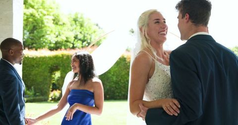 Happy couple and witnesses celebrating outdoor wedding ceremony