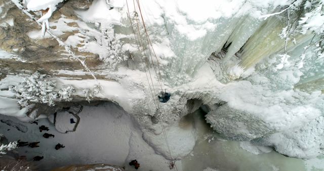 Adventurous Ice Climber Scaling Frozen Waterfall in Winter, Aerial View - Download Free Stock Images Pikwizard.com