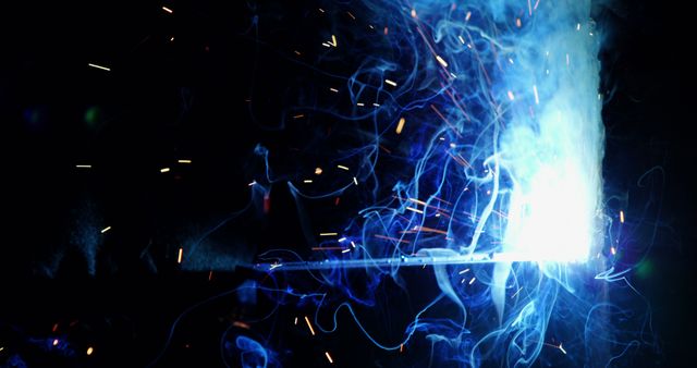 Blue smoke, white heat and sparks flying in dark at metal workshop, copy space - Download Free Stock Photos Pikwizard.com