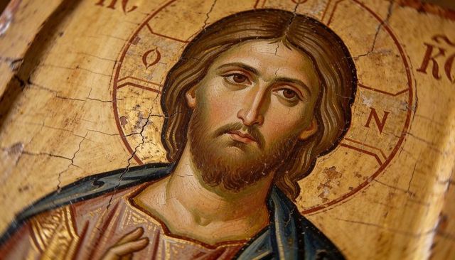 Gilded byzantine christ pantocrator icon with halo and greek letters