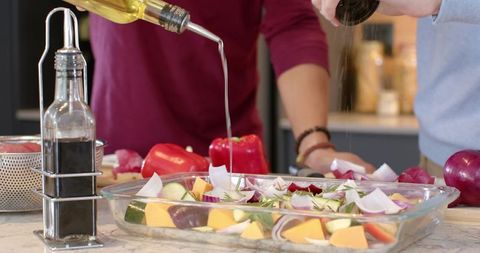 Friends Cooking with Fresh Vegetables in Modern Kitchen