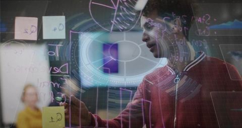 Young Professional Brainstorming Innovative Ideas on Glass Pane