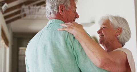 Senior Couple Dancing Together at Home with Joy