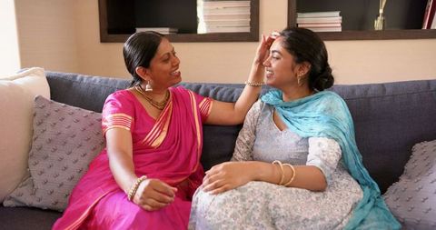 Smiling mother and daughter bonding in comfortable home setting