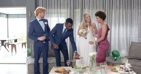 Joyful Multiracial Wedding Celebration Indoors with Friends Toasting