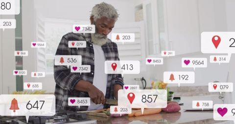 Senior Man Engaging with Social Media While Cooking
