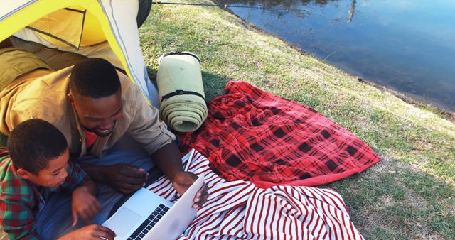 Father and Son Bonding Over Laptop While Camping By Serenity - Download Free Stock Images Pikwizard.com