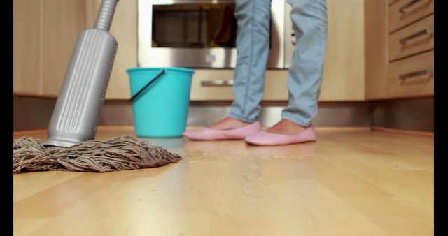 Person Cleaning Hardwood Floor in Modern Kitchen - Download Free Stock Images Pikwizard.com