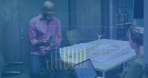 Presenting executive reviewing wind farm model with tablet and interactive data charts