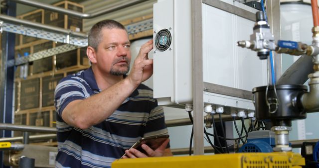 Experienced Technician Inspecting Industrial Equipment in Factory - Download Free Stock Images Pikwizard.com