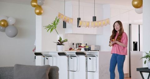 Woman Setting Up for Birthday Celebration with Decorations