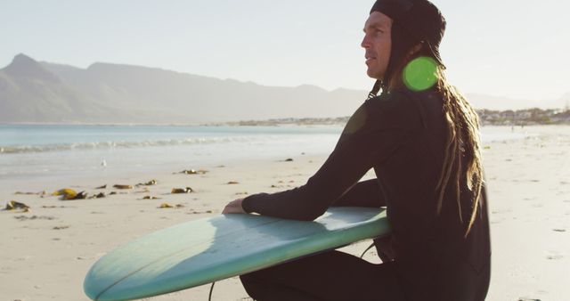 Surfer with Dreadlocks Relaxing on Beach with Surfboard - Download Free Stock Images Pikwizard.com