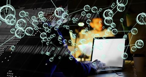 Developer typing on laptop while visualizing network nodes and data flow for collaboration