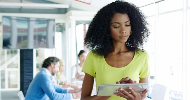 Young Woman Using Tablet in Modern Office Space - Download Free Stock Images Pikwizard.com