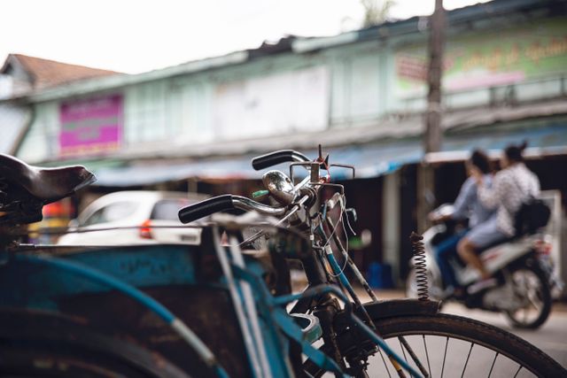 Close-up of vintage bicycle parked on street, illustrating urban transportation lifestyle. Ideal for stories about city living, sustainable commuting, or travel destinations. Could be used in articles focused on exploring local neighborhoods or historical town areas.