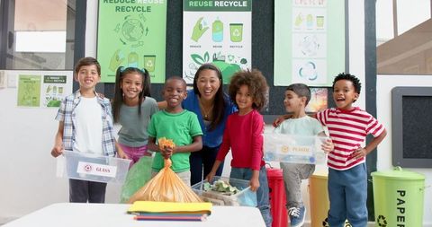 Teacher and Children Learning Recycling Techniques Together
