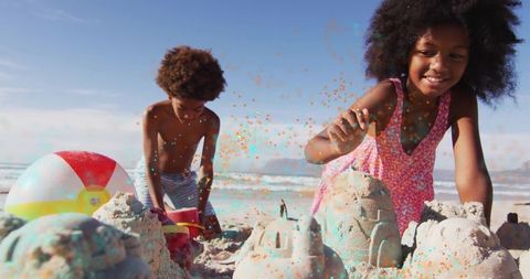 Joyful Siblings Building Sandcastles at Seaside