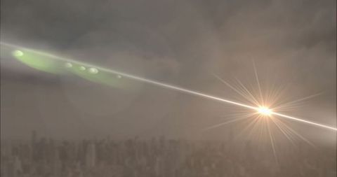 Streaking Light Beam with Starburst Flare over Cityscape Skyline