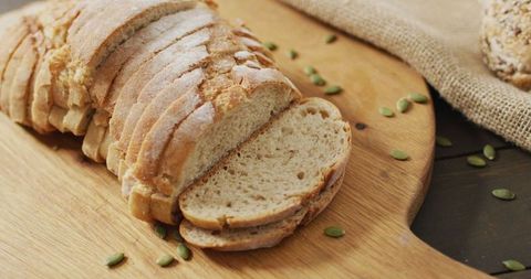 Rustic Sliced Bread on Natural Wooden Board