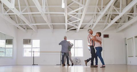 Senior Couples Joyfully Dancing at Ballroom Dance Class