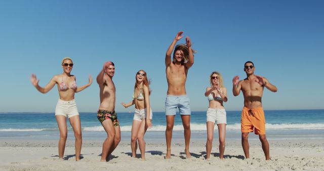 Group of Friends Enjoying Beach Fun Activities Under Sunny Sky - Download Free Stock Images Pikwizard.com