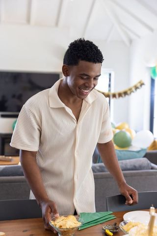 Smiling Male Preparing Festive Table for Celebration