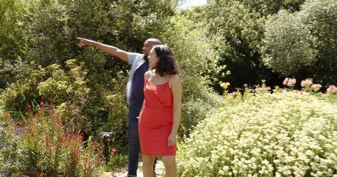 Proposal Moment in Sunny Garden with Happy Couple