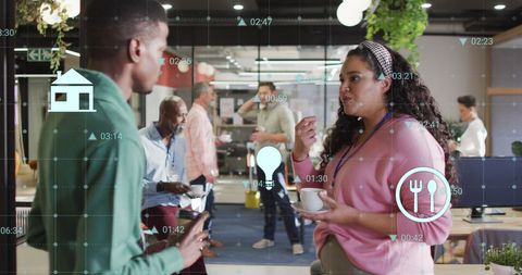 Diverse Coworkers Engaging in Tech-Enhanced Discussion During Tea Break
