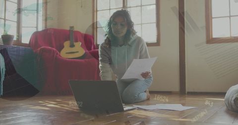 Woman Managing Home Finances with Laptop and Papers