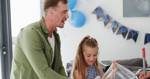 Family Cleaning Together After Birthday Celebration