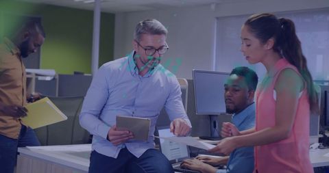 Diverse Coworkers Collaborating on Financial Data Project in Modern Office