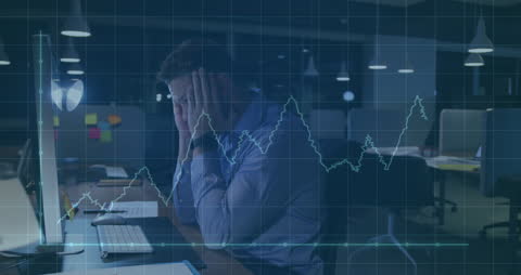 Stressed Businessman Analyzing Declining Financial Data Late at Night