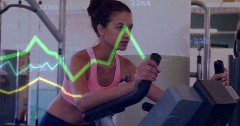 Woman pedaling on upright bike tracking fitness analytics and performance metrics overlay