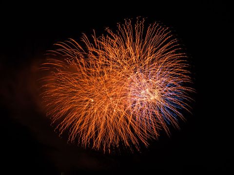 Vibrant fireworks displaying orange and blue colors