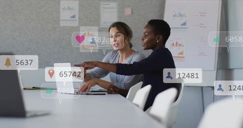 Collaborating over laptop with social media metrics overlays in modern conference room