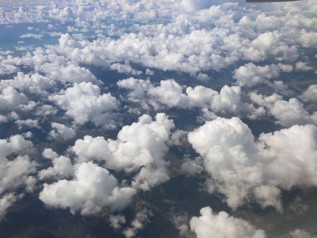 Aerial View of Fluffy White Clouds Over Green Landscape - Download Free Stock Photos Pikwizard.com