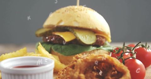 Grilled beef burger featuring melted cheddar, pickles, fries and crispy onion ring
