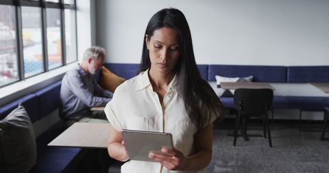 Businesswoman Using Tablet in Modern Office Setting