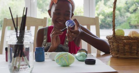 Young Girl Joyfully Painting Easter Eggs at Home - Download Free Stock Images Pikwizard.com