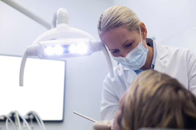 Transparent Dentist Conducting Exam on Patient Under Bright Light - Download Free Stock Videos Pikwizard.com