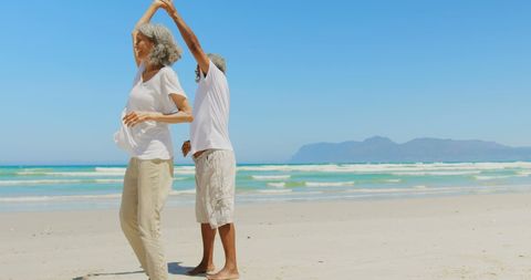 Senior Couple Dancing Joyfully on Sunlit Beach - Download Free Stock Images Pikwizard.com