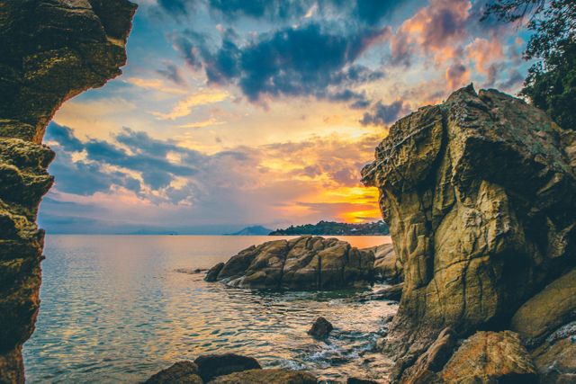 Scenic Coastal Sunset with Dramatic Rock Formations and Vibrant Sky - Download Free Stock Photos Pikwizard.com
