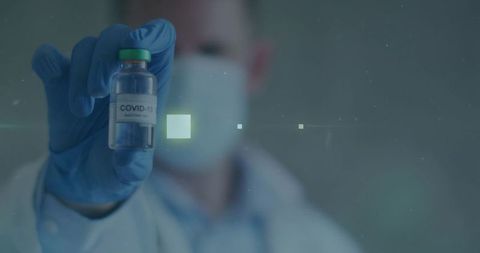 Healthcare Professional Showing COVID-19 Vaccine Vial in Laboratory