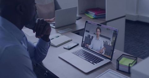 Business professional watching online presentation in modern office
