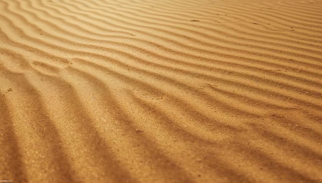 Rippled sand dunes with wind-formed patterns in arid desert
